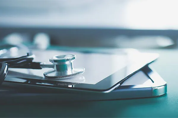 Close up of a stethoscope lying on a tablet, representing advanced functional medicine testing offered by Yashoda Singh, MD in Hamilton-Toronto-Niagara.
