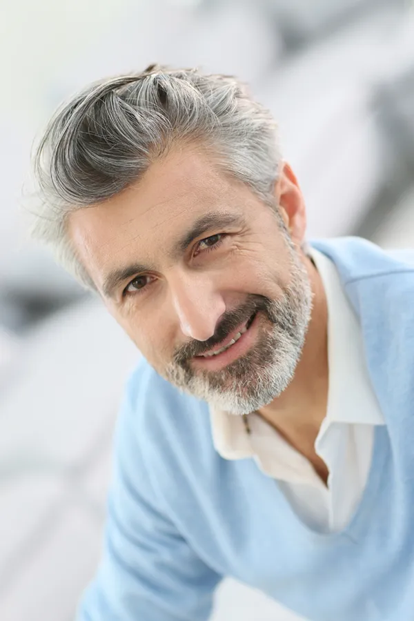 A middle-aged man with a full head of salt and pepper hair. Get Ayurvedic Haircare treatment from Yashoda Singh, MD in Hamilton-Toronto-Niagara.