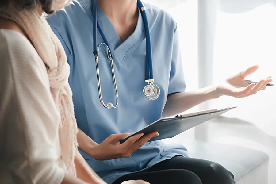 A clinician goes over a health evaluation with a patient. Get comprehensive health evaluations from Yashoda Singh, MD in Hamilton-Toronto-Niagara.