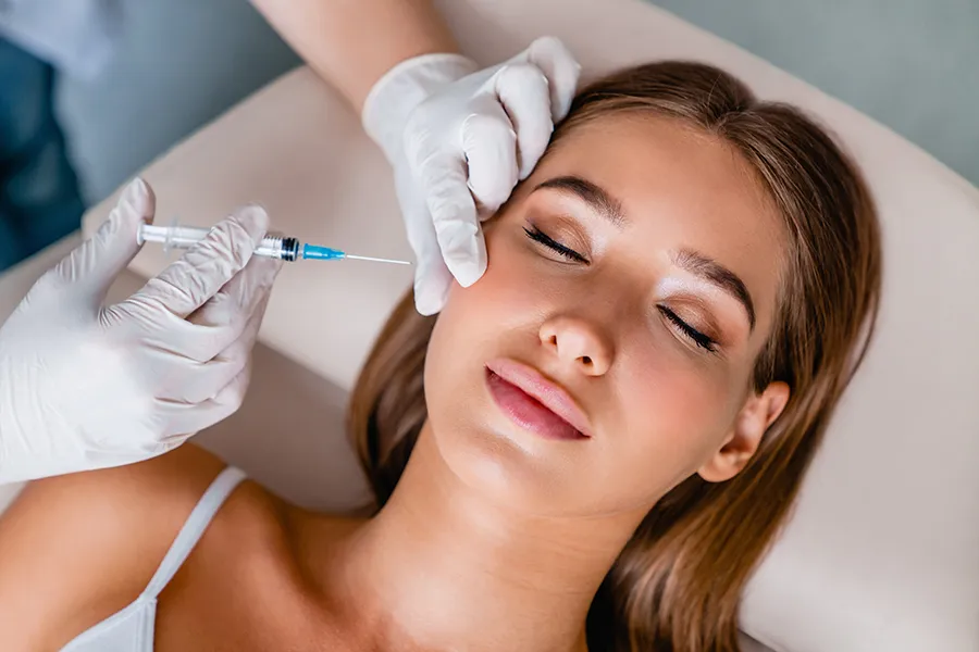 A woman receiving facial injections. Get Dysport facial injections from Yashoda Singh, MD in Hamilton-Toronto-Niagara.