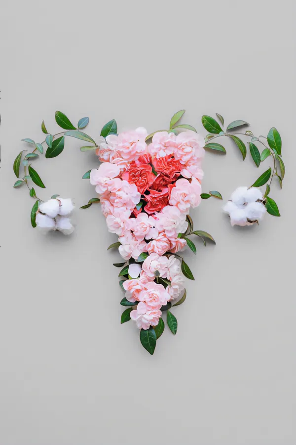 Flowers on a gray background, arranged in the shape of the female reproductive system, representing Endometriosis treatment from Yashoda Singh, MD in Hamilton-Toronto-Niagara.