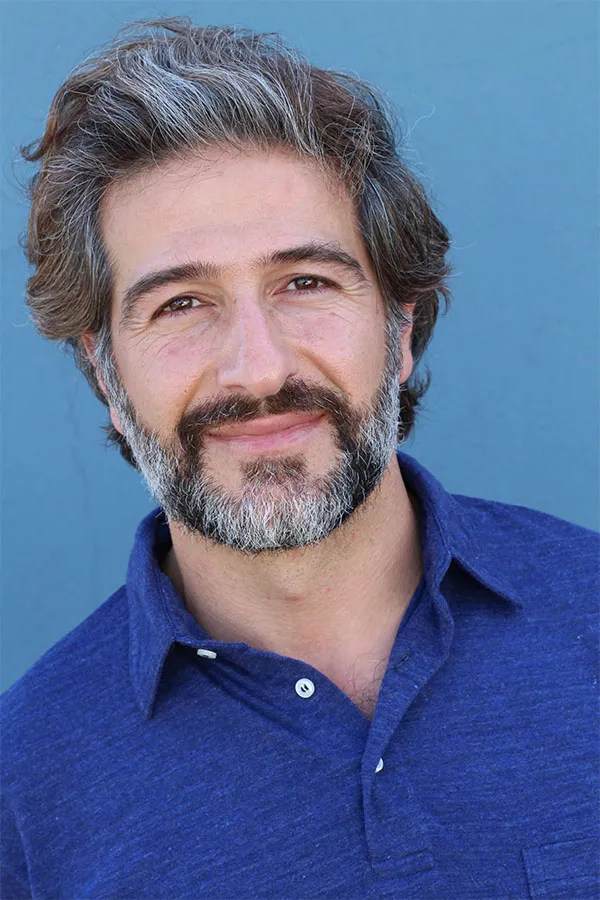 A middle-aged man with full hair and beard. Get a consultation with hair analysis specialist Yashoda Singh, MD in Hamilton-Toronto-Niagara.