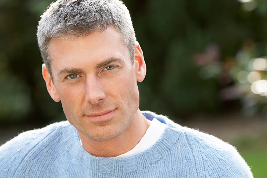 A middle-aged man with short, full hair. Schedule High-Frequency Scalp Stimulation treatment from Yashoda Singh, MD in Hamilton-Toronto-Niagara.