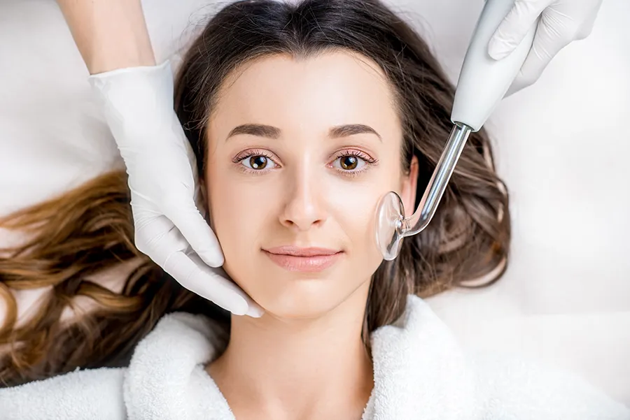 A woman getting high-frequency skin therapy. Get high-frequency skin therapy from Yashoda Singh, MD in Hamilton-Toronto-Niagara.