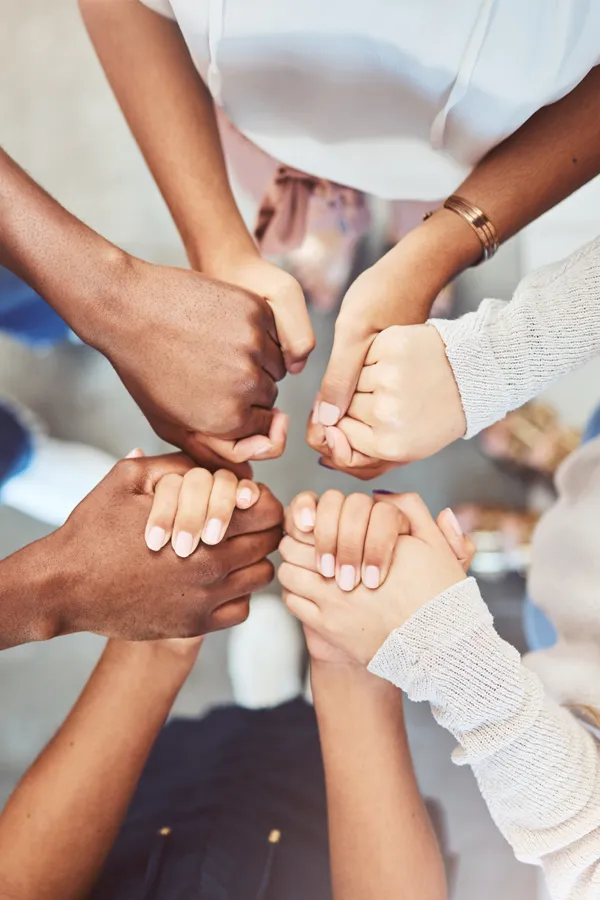 A group of people clasping hands. Get hormonal mental health treatment from Yashoda Singh, MD in Hamilton-Toronto-Niagara.