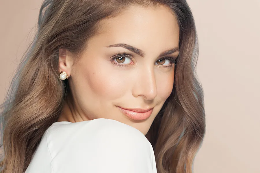 A beautiful brunette woman. Schedule Kybella Facial Injections from Yashoda Singh, MD in Hamilton-Toronto-Niagara.