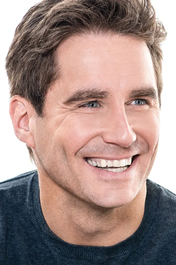 A middle-aged man with a tight, smooth brow and eye area. Get laser eye and brow treatment from Yashoda Singh, MD in Hamilton-Toronto-Niagara.