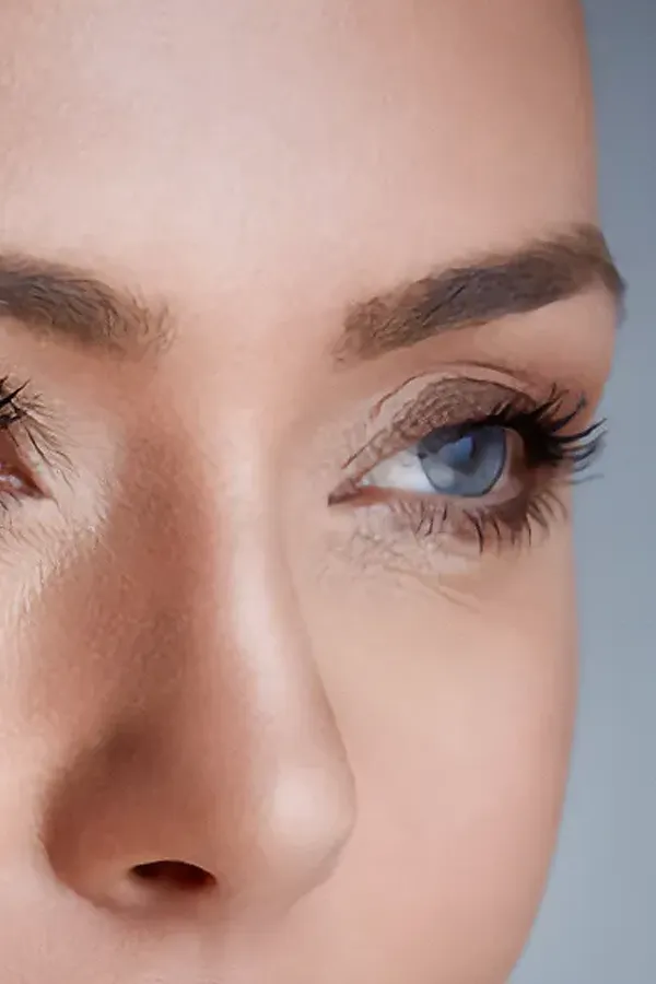 Close-up on a woman's well-maintained brow and eyelashes. Get brow and lash serum from Yashoda Singh, MD in Hamilton-Toronto-Niagara.